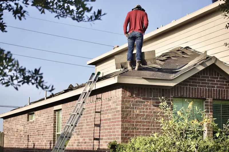 Professional roofer working on a residential roof in Zumbrota